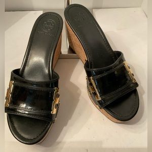 Tory Burch black patent wedge with T logo.